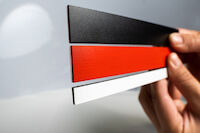 PROMASEAL®-PL anthracite grey fire protection laminate, self-adhesive with a decorative surface in red, black and white
