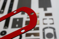 PROMASEAL® STAMPED PARTS with holes and a red lamination